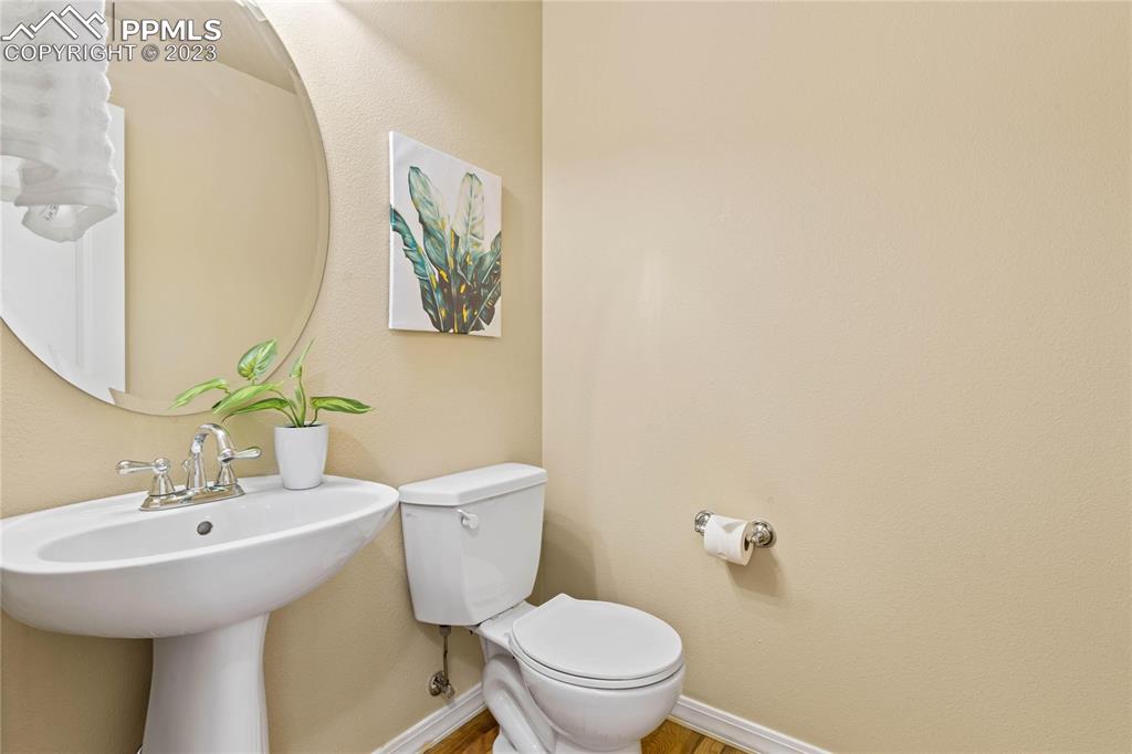 2423 Cinnabar Road Colorado Springs, CO 80921 - Photo 10 of 40 a bathroom with a toilet a sink and mirror