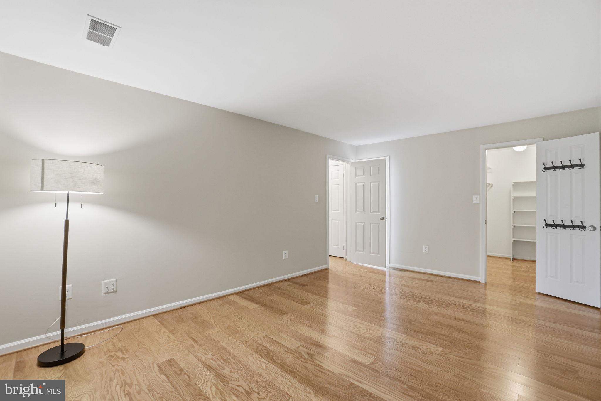 1495 Church Hill Place Reston, VA 20194 - Photo 15 of 27 a view of an empty room with wooden floor and a window