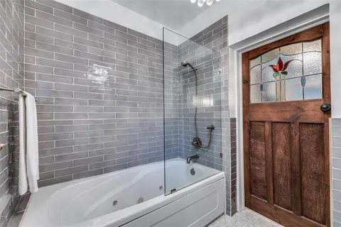 a bathroom with a bathtub and a shower