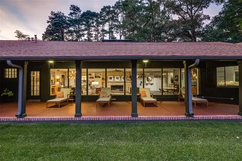 a view of a house with backyard porch and sitting area