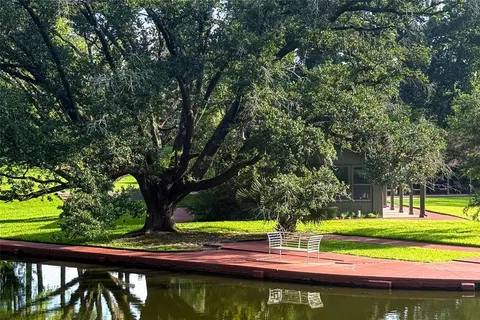 an aerial view of a house with swimming pool and garden