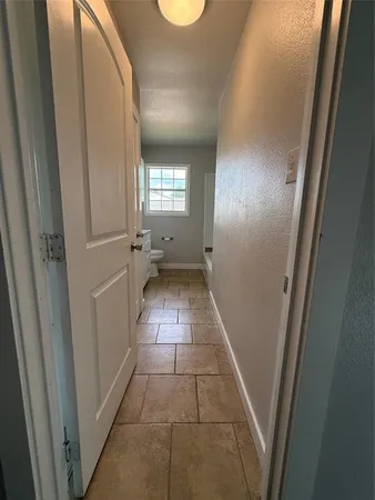 a view of an empty room and window and wooden floor