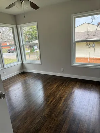 a house is sitting in middle of the green field