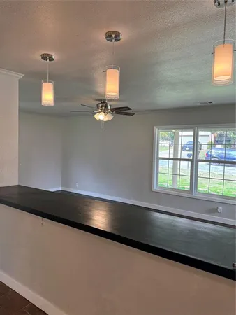a large kitchen with cabinets and a stove top oven