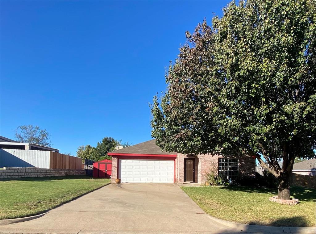 a view of a house with a yard and tree