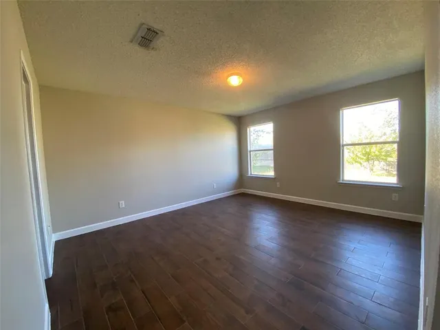 a bathroom with a sink a toilet a tub and a large mirror
