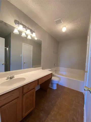 a bathroom with a glass door shower and a sink