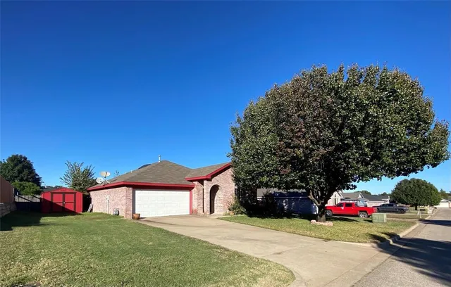 a view of a house with a yard and garage