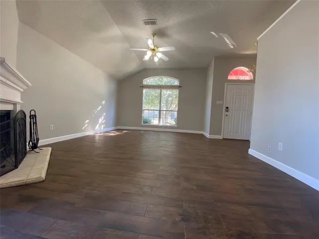 wooden floor in an empty room with a window