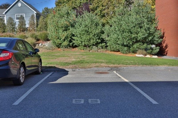 74 Beach Street, Unit 211 Woburn, MA 01801 - Photo 14 of 14 a view of a house with a yard and garage