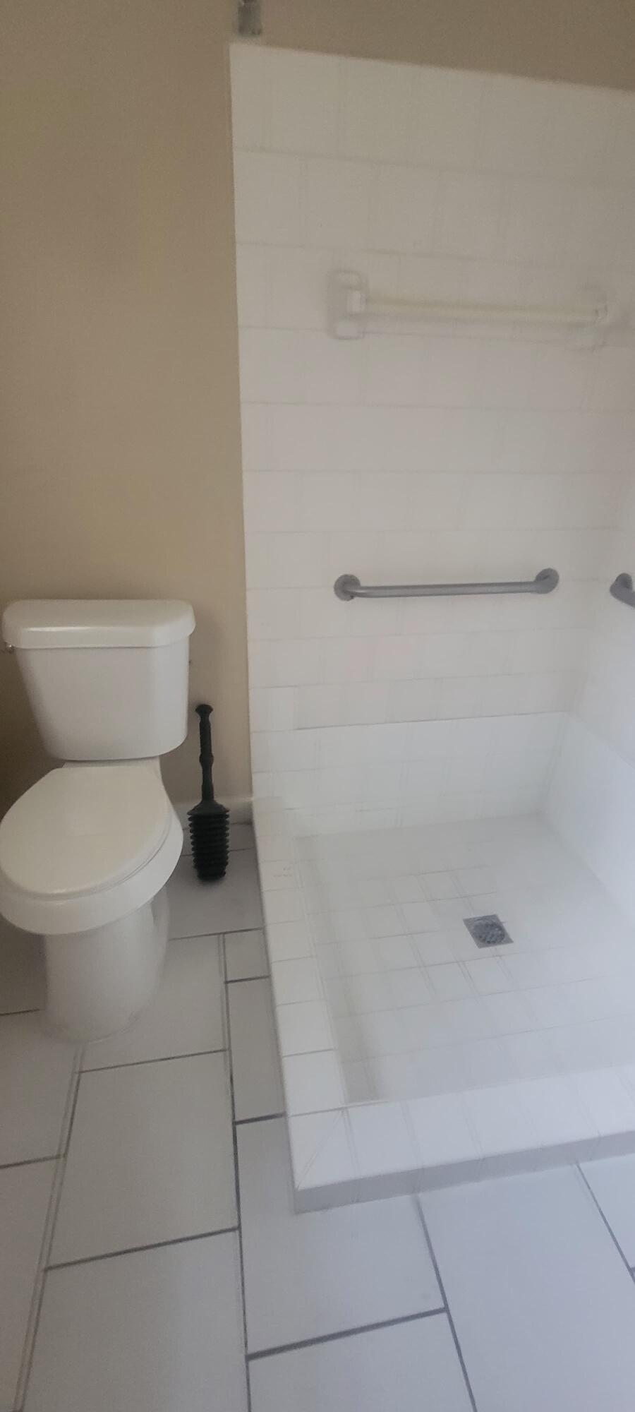 5926-5934 Taft Street Hollywood, FL 33021 - Photo 11 of 13 a bathroom with a toilet and a shower