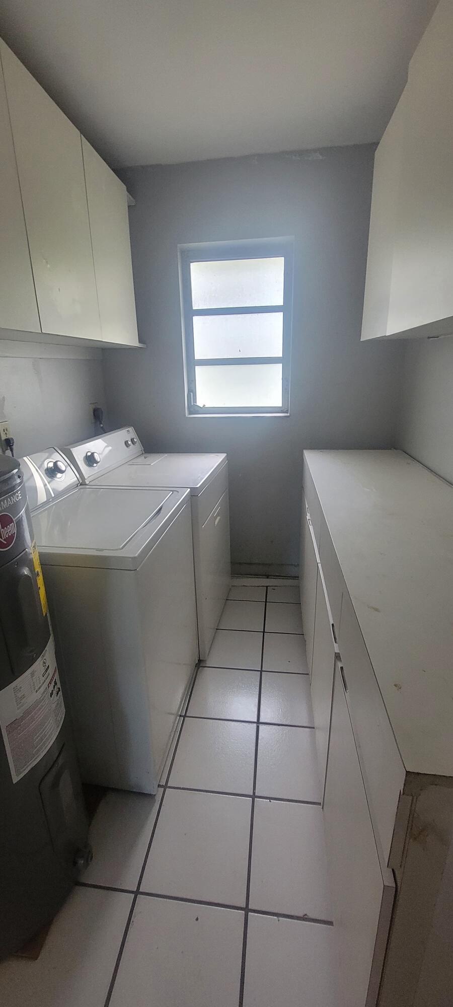 5926-5934 Taft Street Hollywood, FL 33021 - Photo 12 of 13 a utility room with washer and dryer