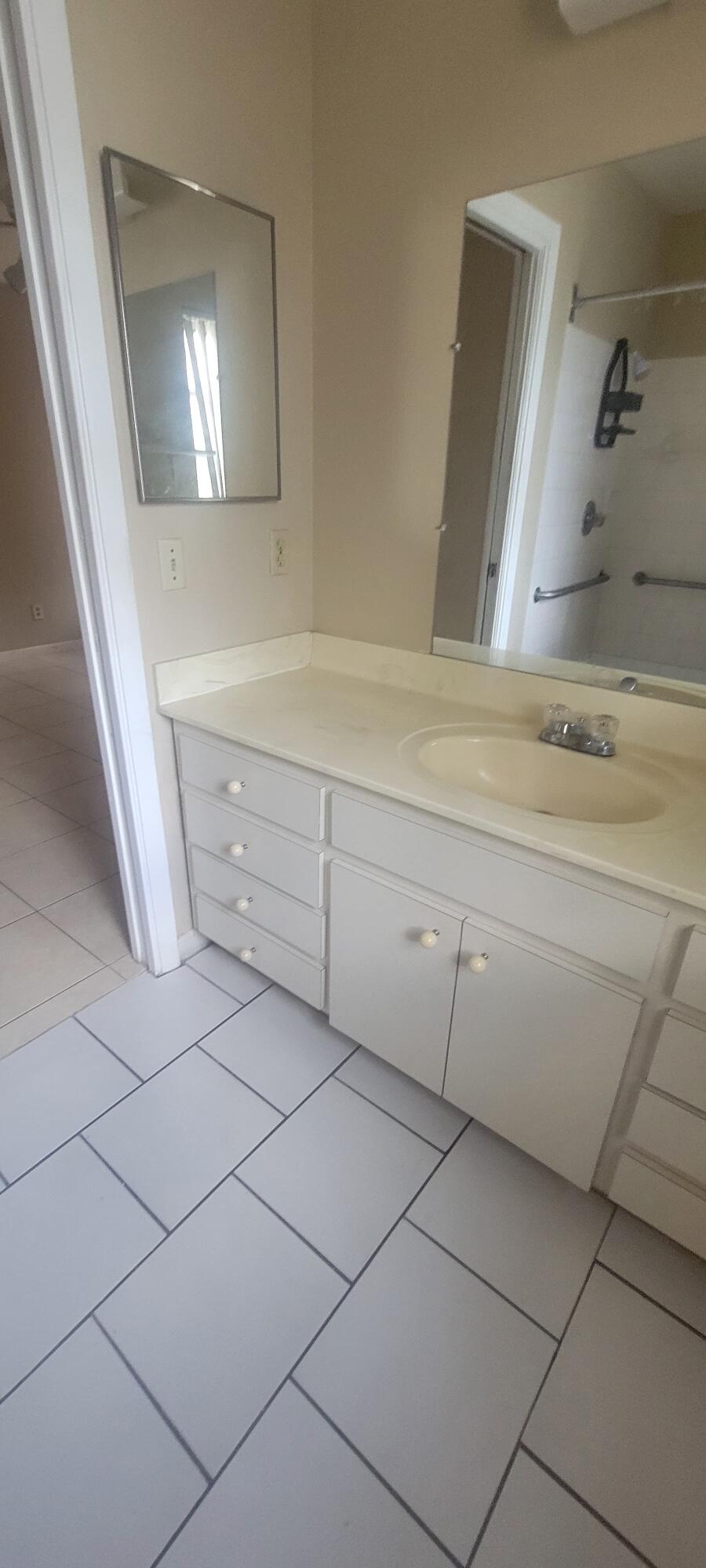 5926-5934 Taft Street Hollywood, FL 33021 - Photo 7 of 13 a bathroom with a sink and a mirror
