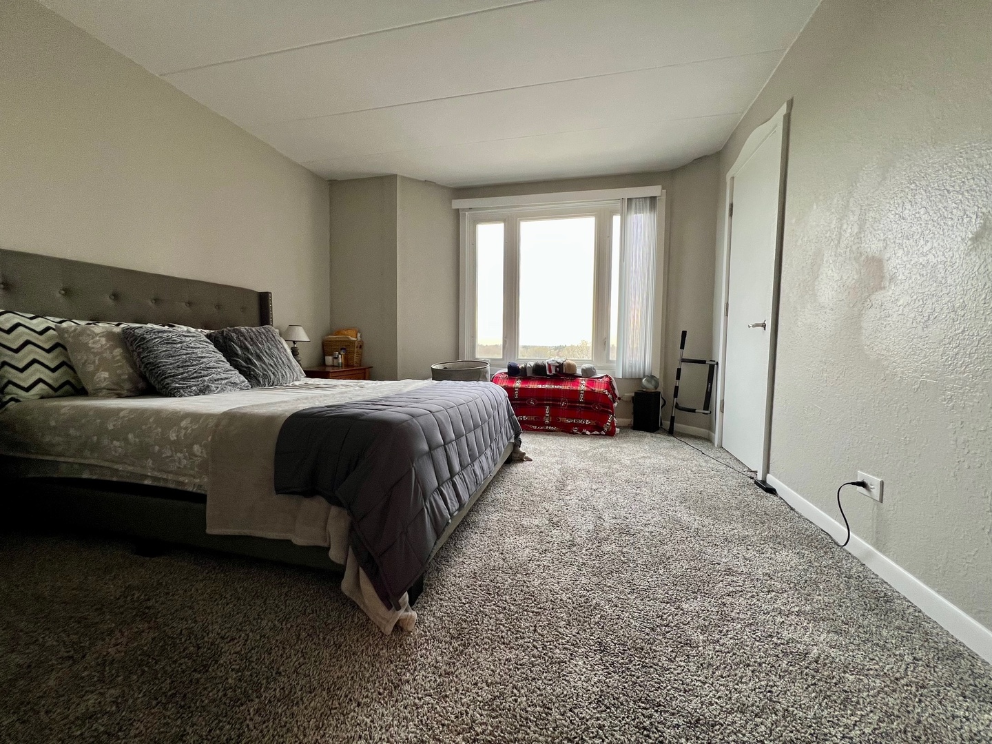 1 Renaissance Place, Unit 719 Palatine, IL 60067 - Photo 19 of 34 a spacious bedroom with a bed and a couch
