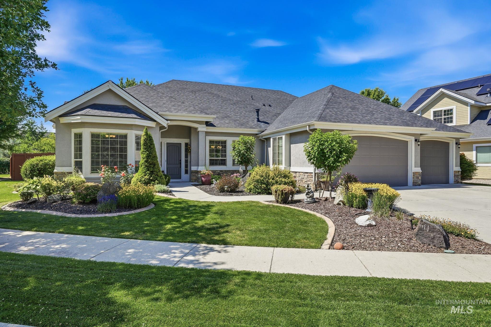 3969 North Hollymount Way Meridian, ID 83646 - Photo 2 of 47 Siding exterior with stone accents and a multi-car garage