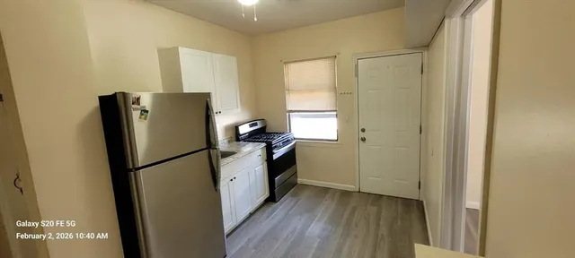 a kitchen with refrigerator a washer and dryer