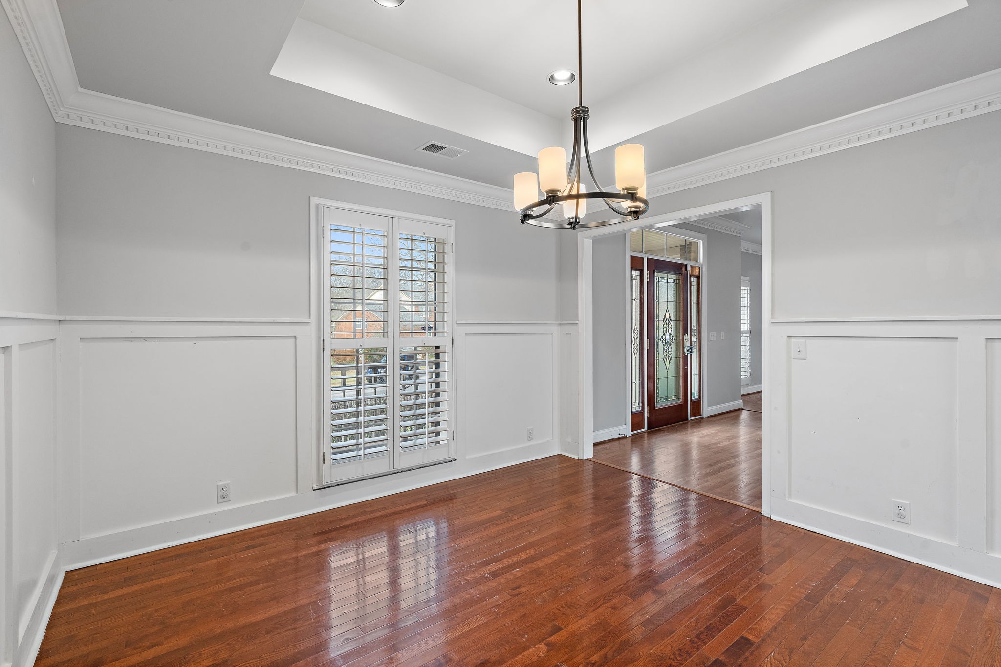 6916 Sunderland Circle Nashville, TN 37221 - Photo 12 of 43 a view of an empty room with wooden floor fridge and a window