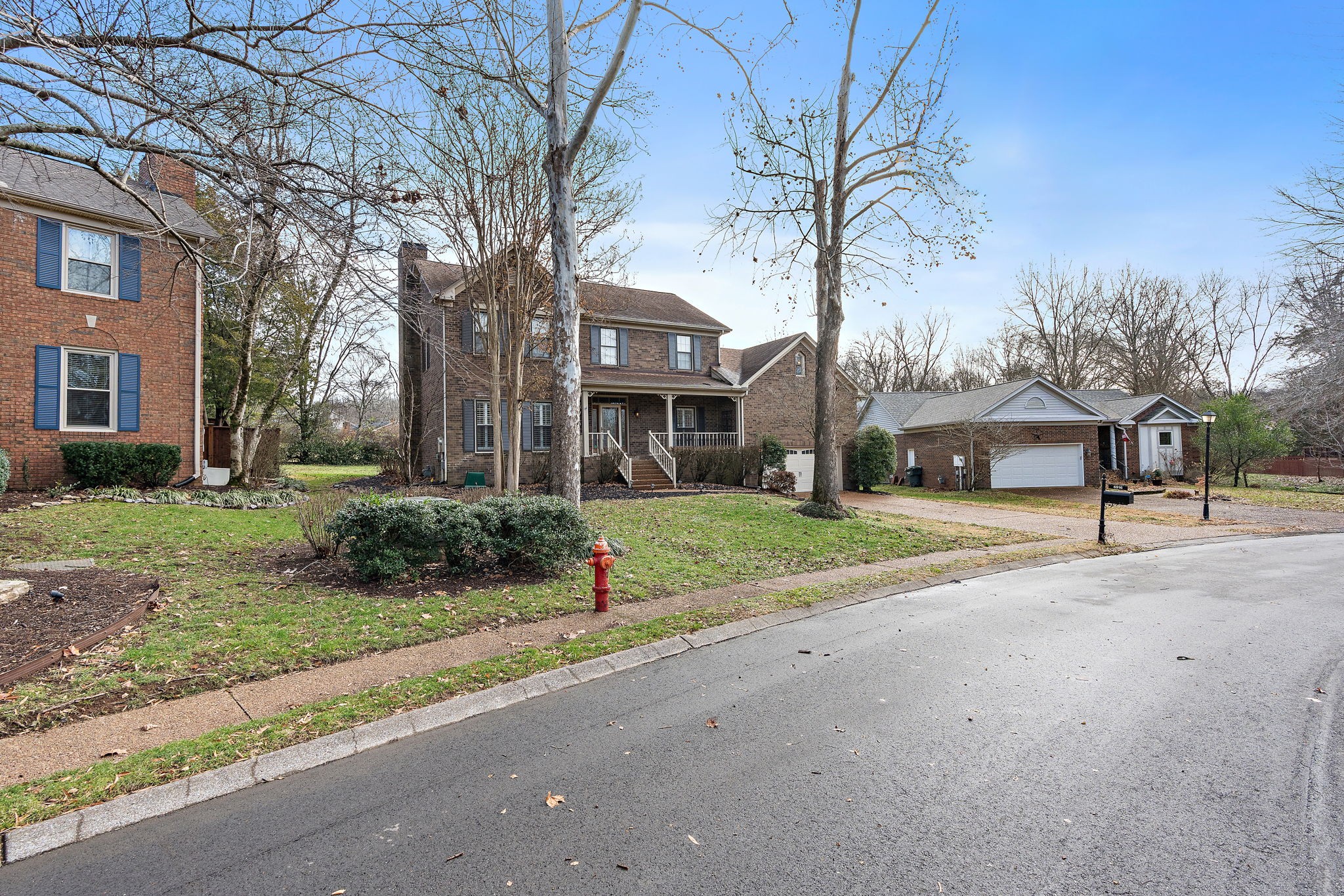 6916 Sunderland Circle Nashville, TN 37221 - Photo 2 of 43 a view of a house with a yard and large trees