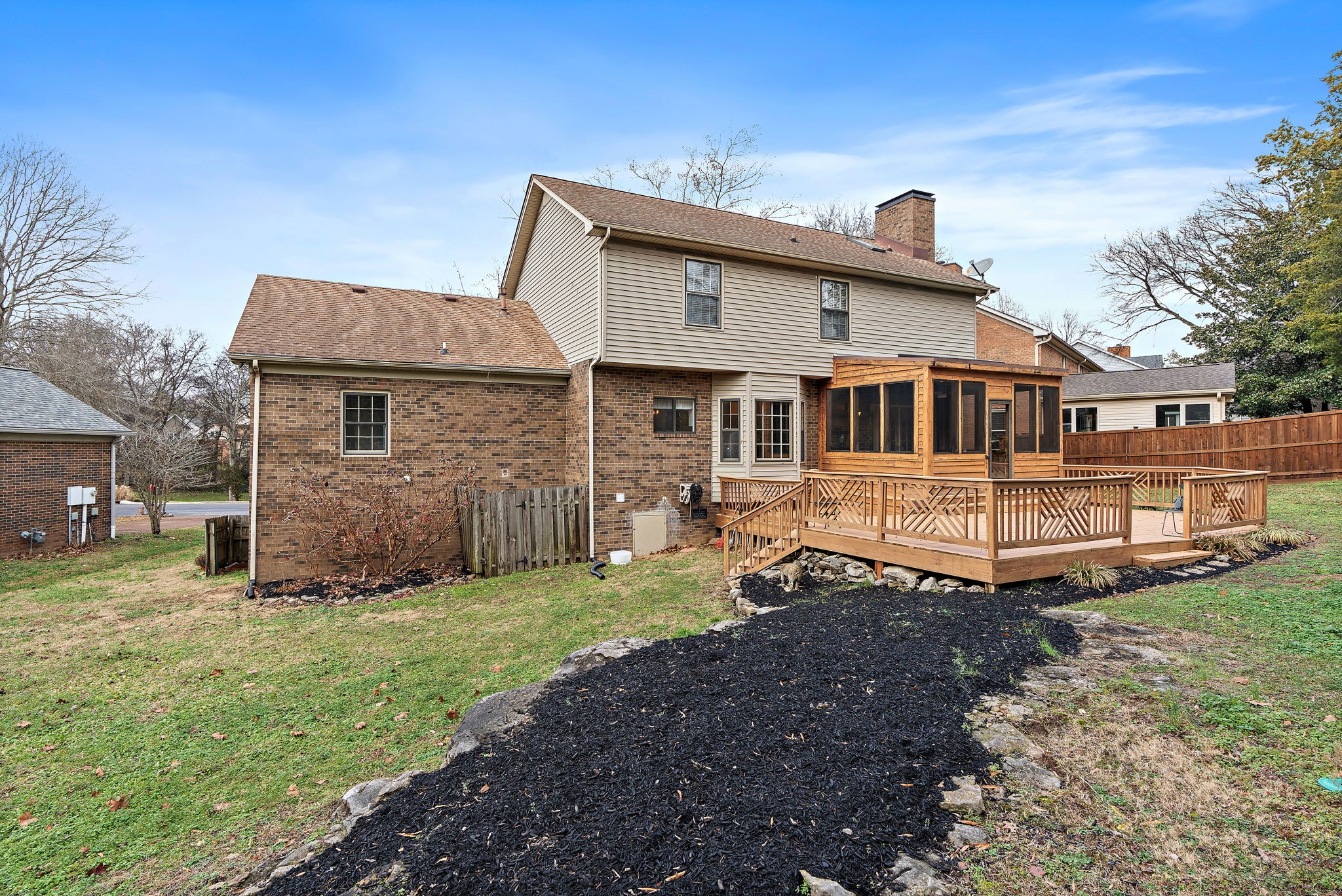 6916 Sunderland Circle Nashville, TN 37221 - Photo 41 of 43 a front view of a house with a yard table and chairs