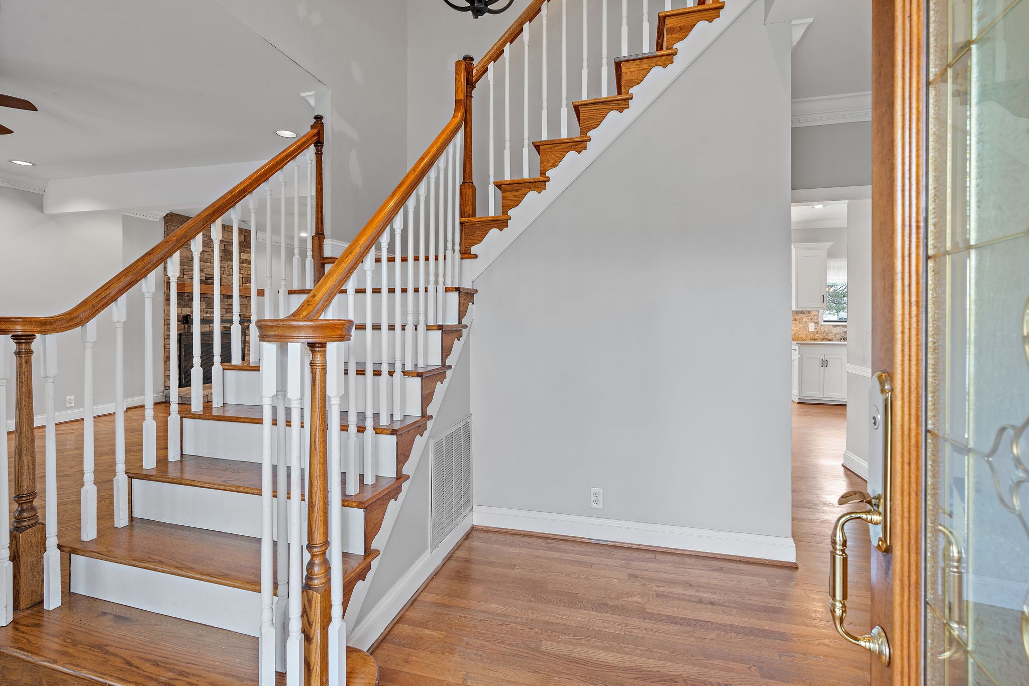 6916 Sunderland Circle Nashville, TN 37221 - Photo 6 of 43 a view of staircase with wooden floor and white walls