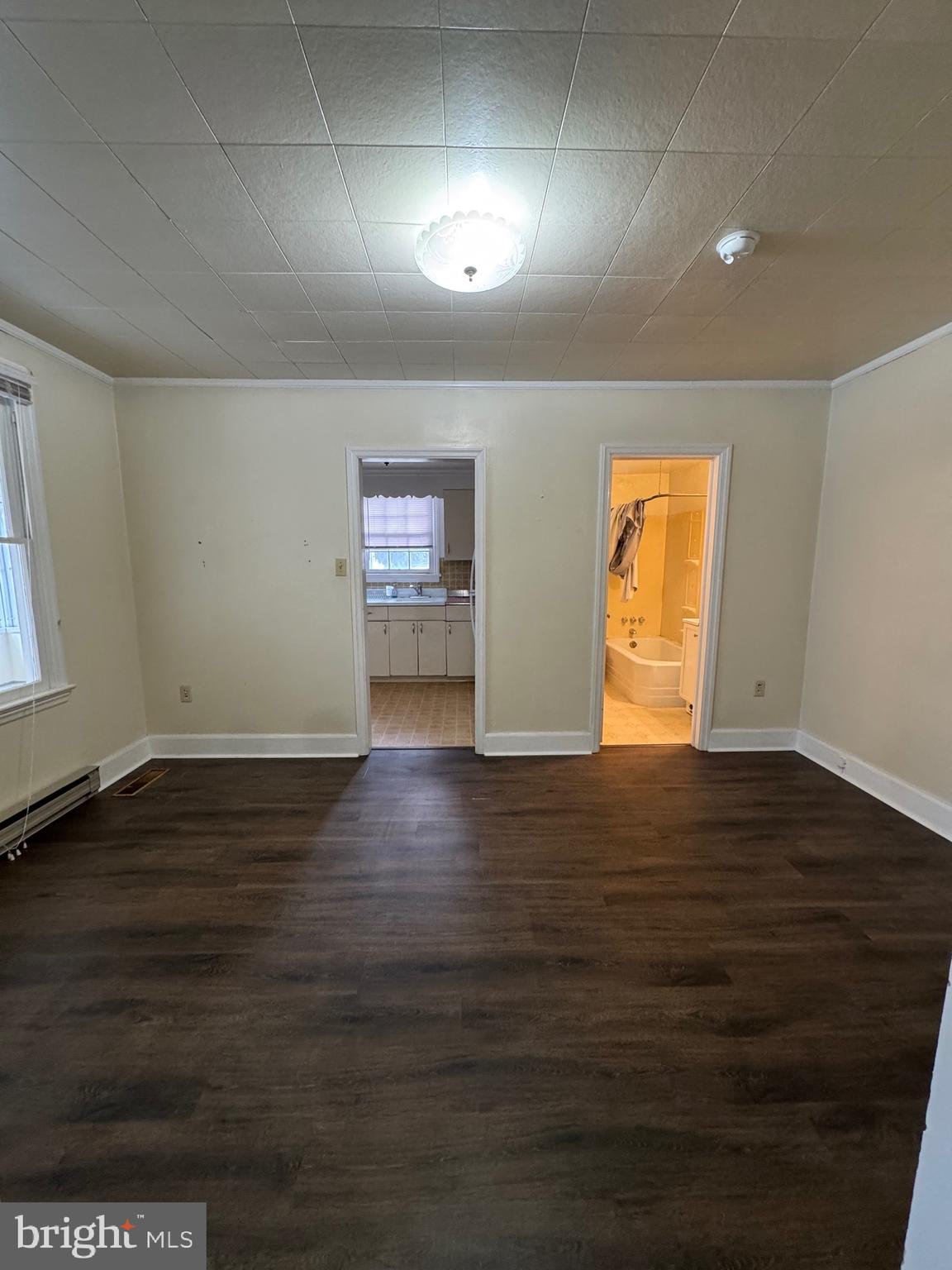 117 East State Street, Unit 1 Quarryville, PA 17566 - Photo 3 of 6 a view of an empty room with wooden floor and a window