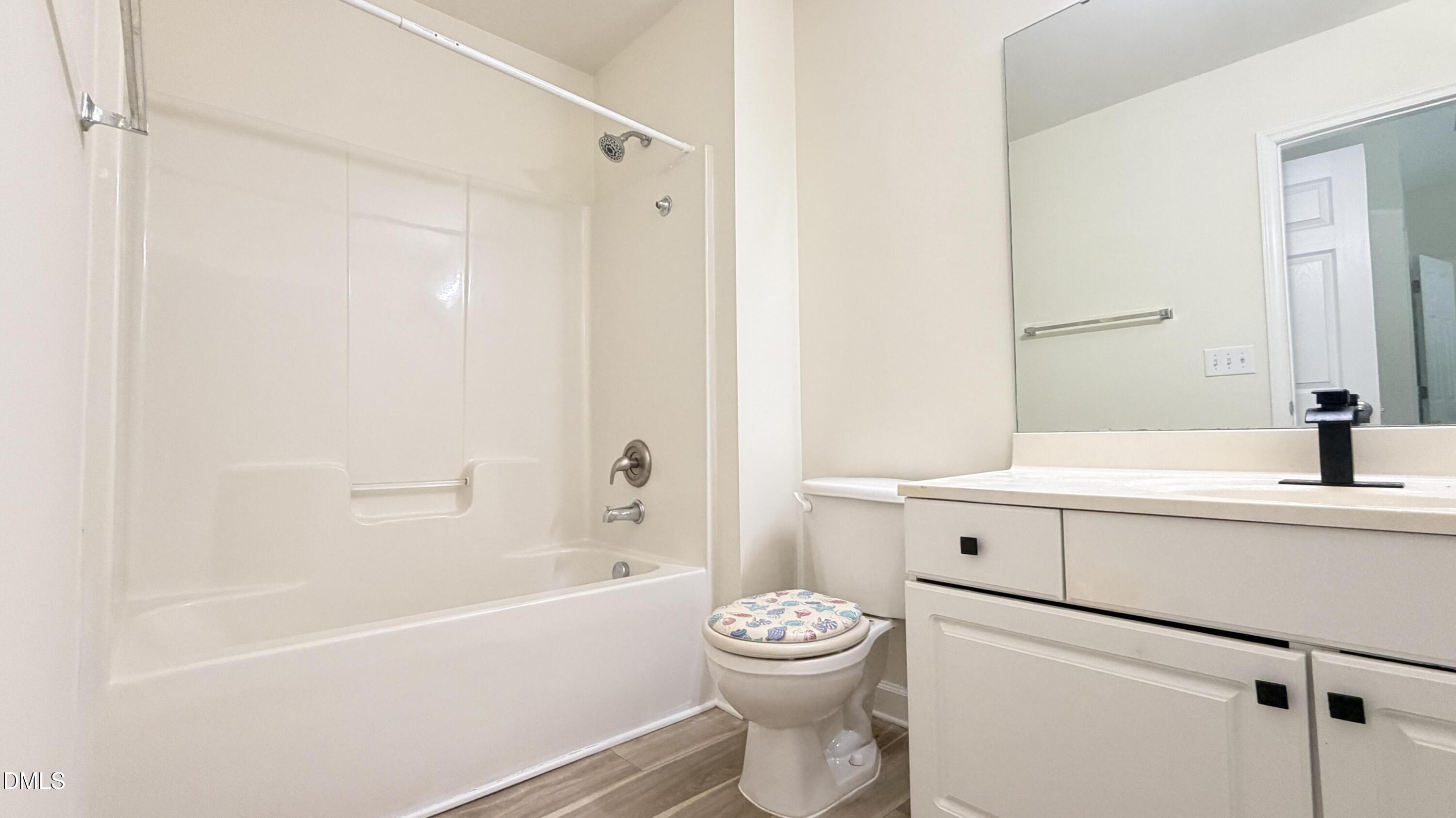4123 Standing Rock Way Raleigh, NC 27604 - Photo 27 of 29 a bathroom with a sink a toilet and a bathtub