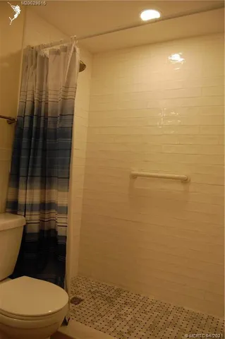 a bathroom with a toilet and a shower