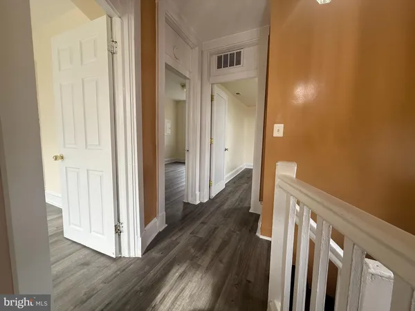 wooden floor in an empty room with a mirror