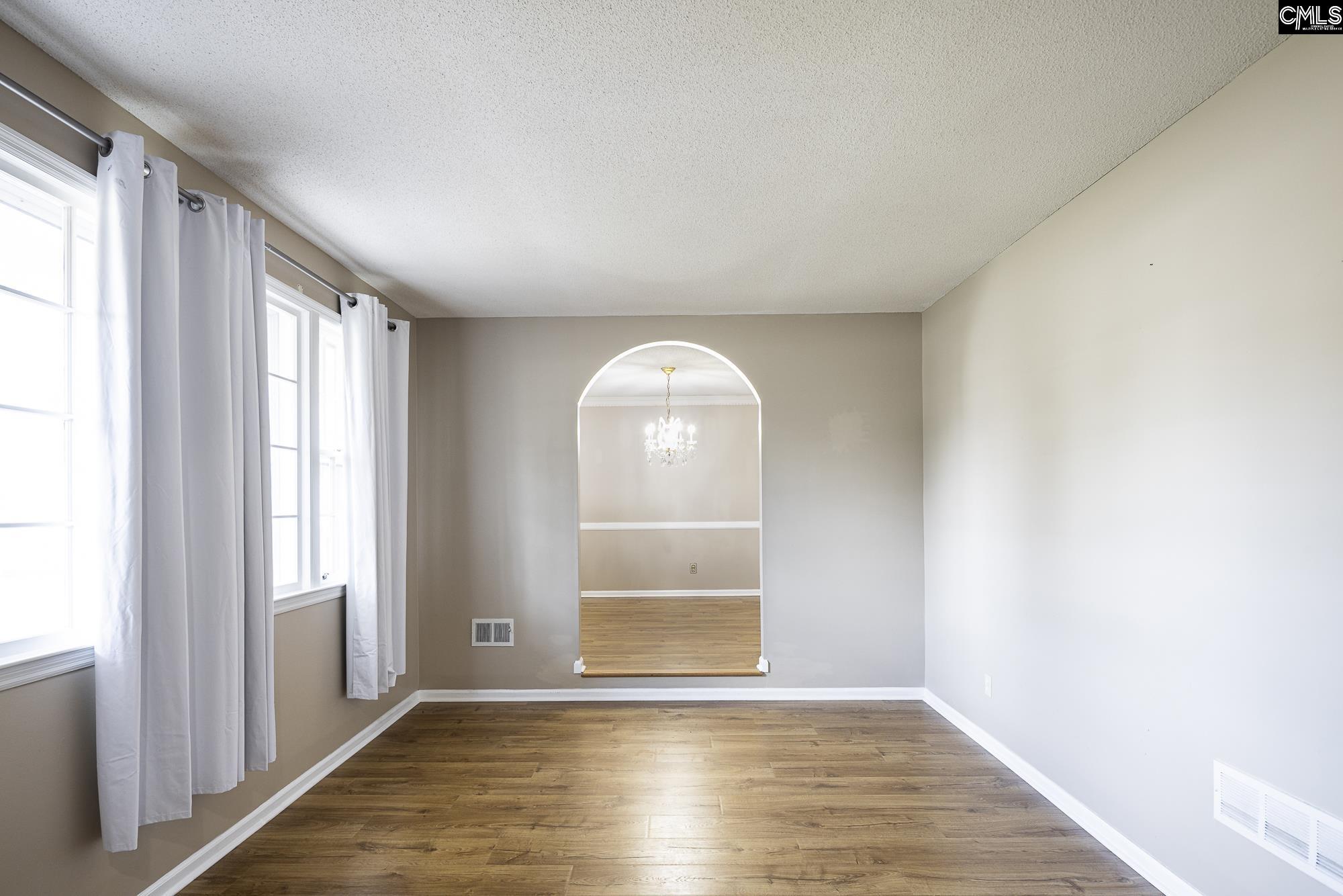 4083 Platt Springs Road West Columbia, SC 29170 - Photo 3 of 35 an empty room with wooden floor cabinet and windows