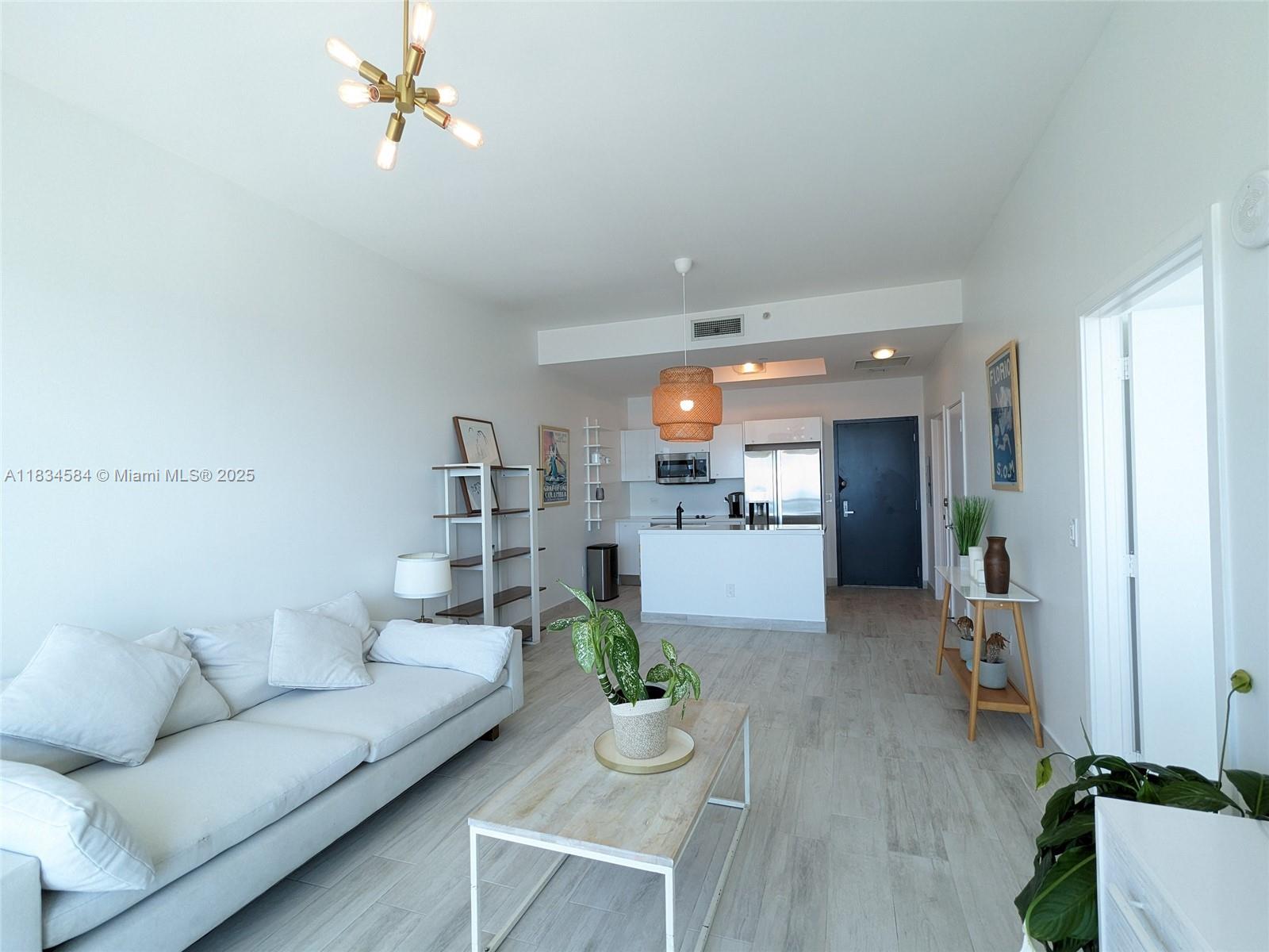888 Biscayne Boulevard, Unit 4702 Miami, FL 33132 - Photo 12 of 27 a living room with furniture and wooden floor