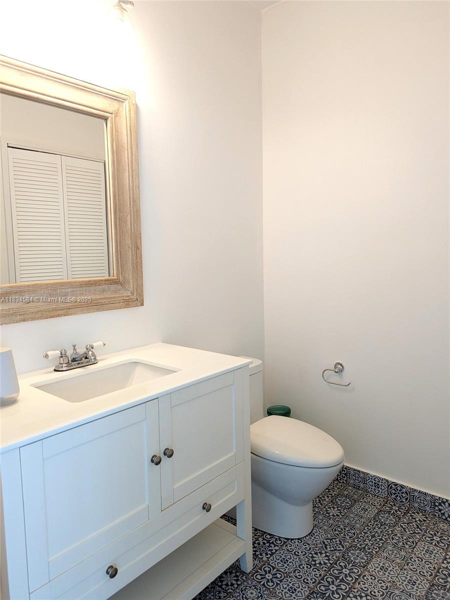 888 Biscayne Boulevard, Unit 4702 Miami, FL 33132 - Photo 13 of 27 a bathroom with a granite countertop toilet and a sink