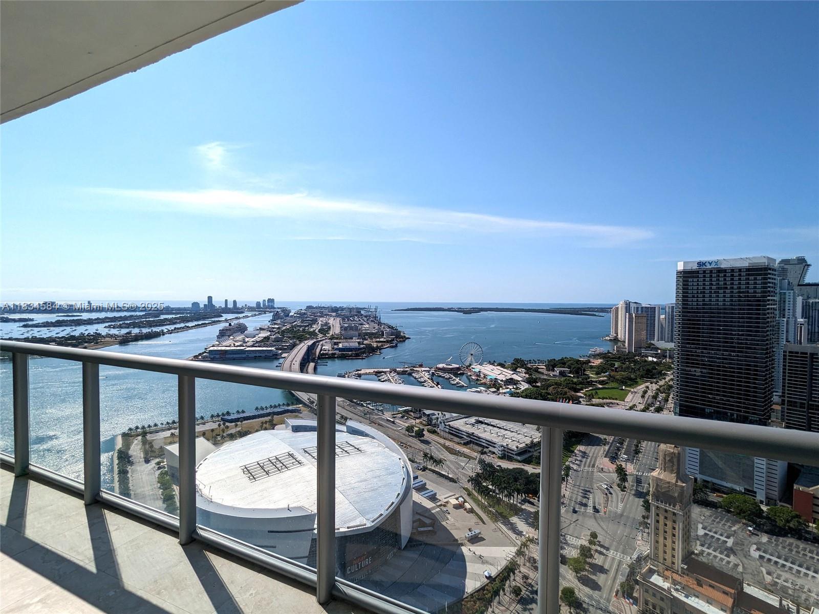 888 Biscayne Boulevard, Unit 4702 Miami, FL 33132 - Photo 15 of 27 a view of a balcony with wooden floor and fence