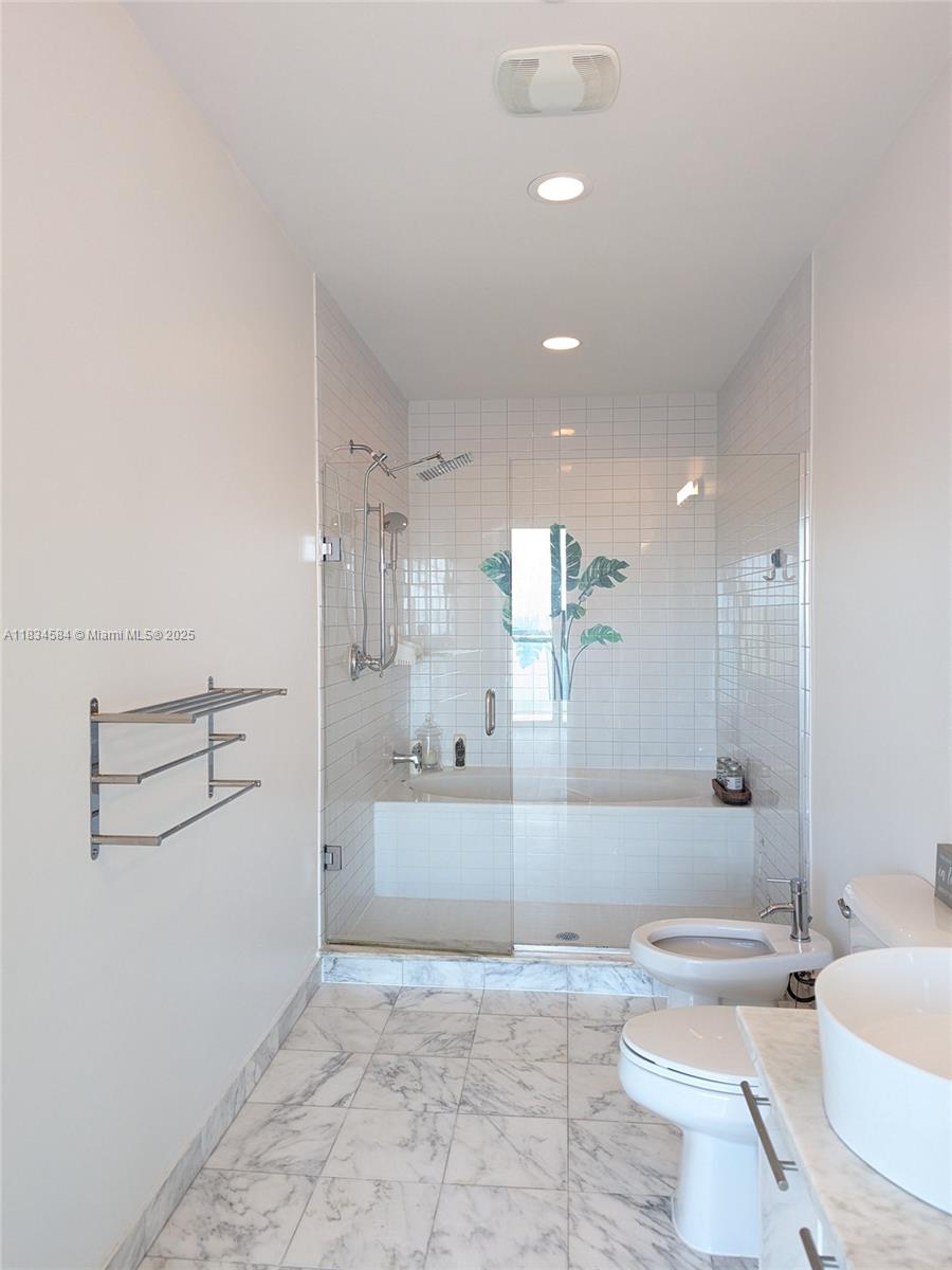 888 Biscayne Boulevard, Unit 4702 Miami, FL 33132 - Photo 27 of 27 a bathroom with a sink a toilet and shower