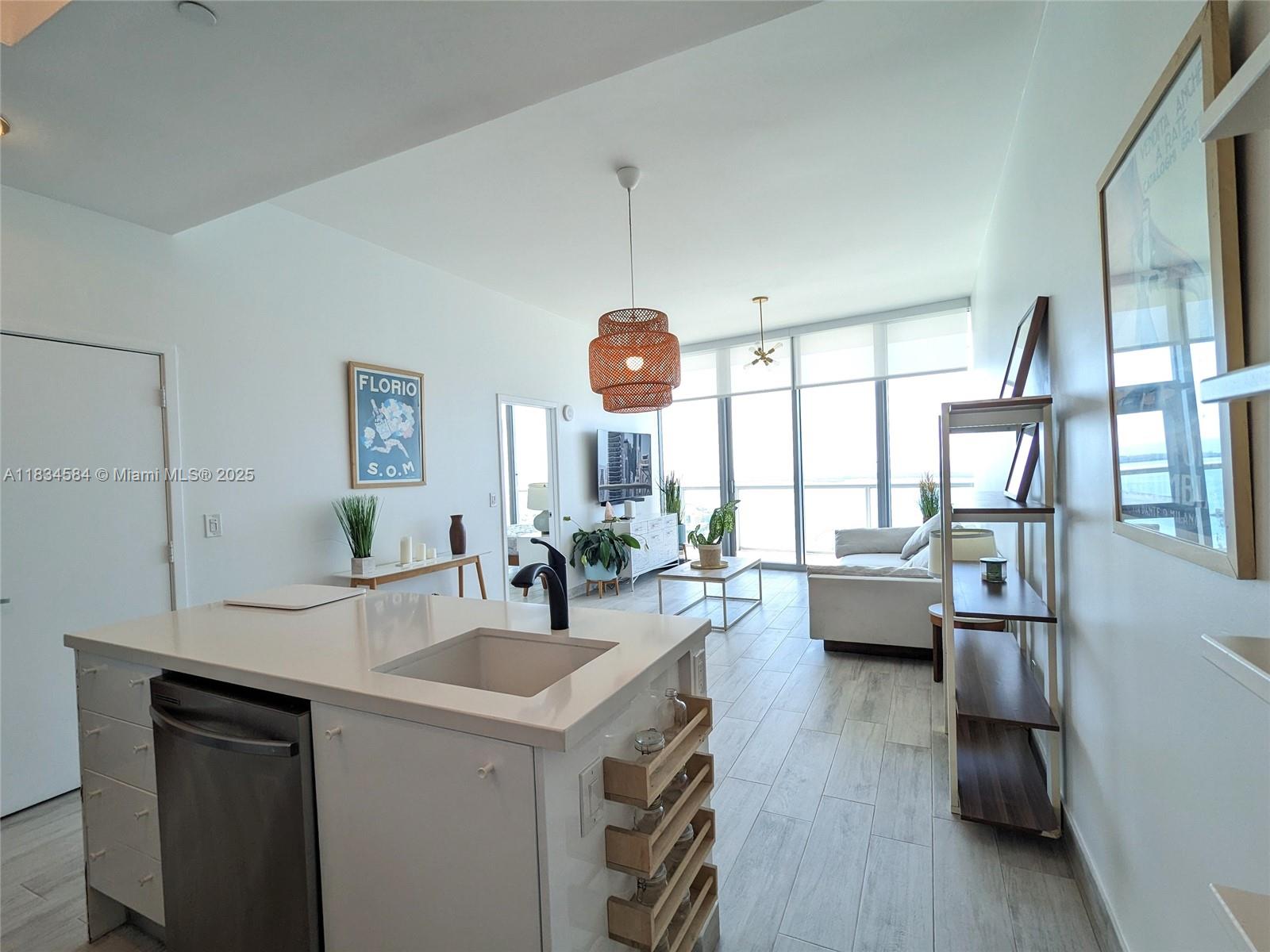 888 Biscayne Boulevard, Unit 4702 Miami, FL 33132 - Photo 4 of 27 a very nice looking living room with a large window wooden floor and furniture