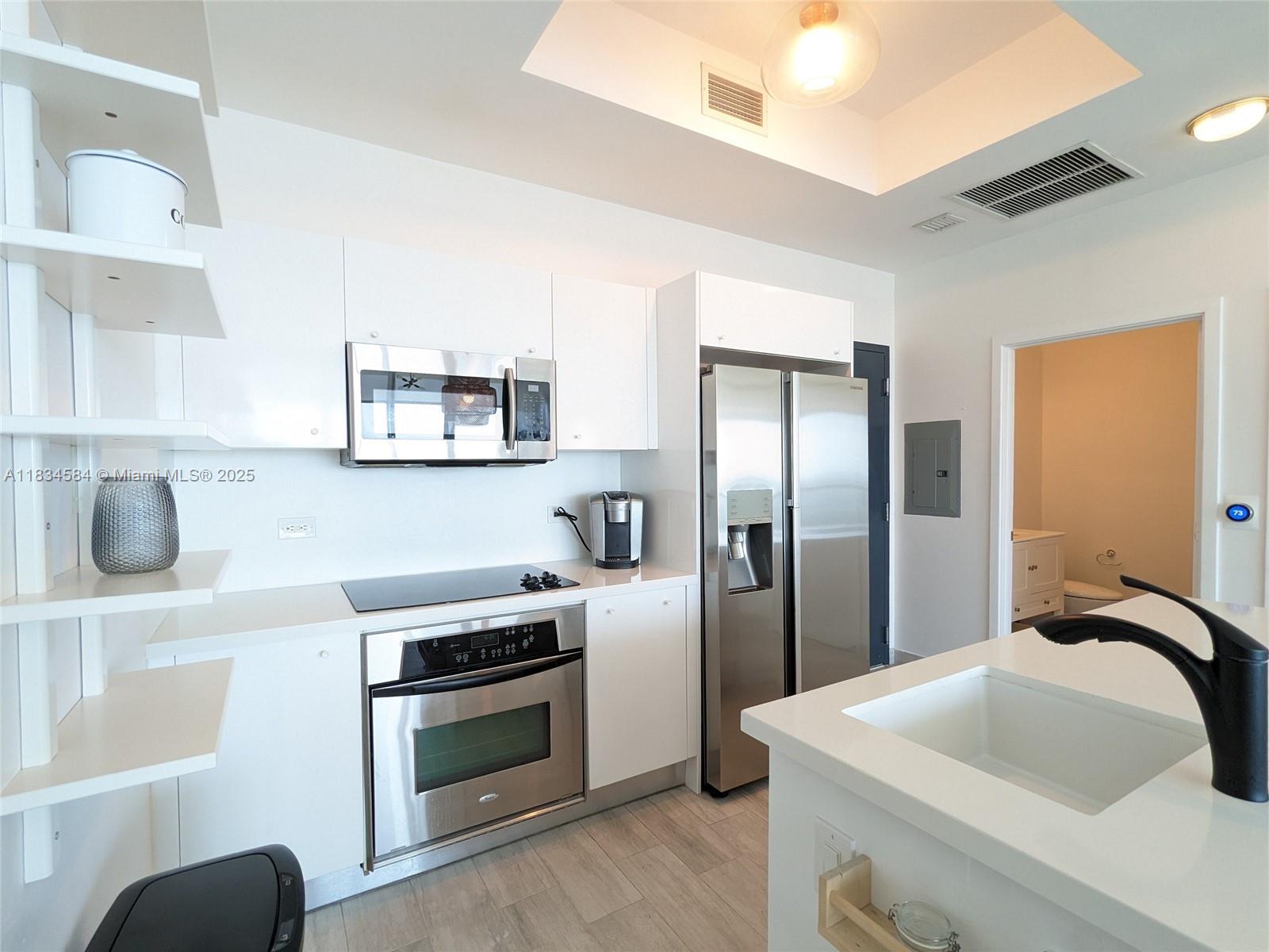 888 Biscayne Boulevard, Unit 4702 Miami, FL 33132 - Photo 7 of 27 a kitchen with stainless steel appliances granite countertop a sink and a refrigerator