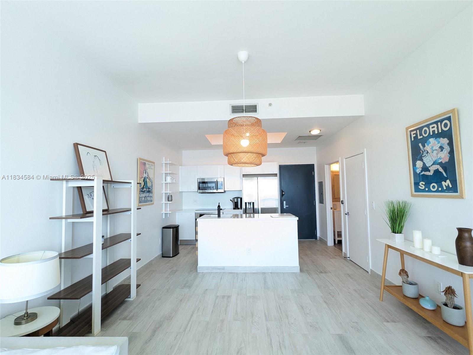 888 Biscayne Boulevard, Unit 4702 Miami, FL 33132 - Photo 8 of 27 a living room with furniture and a wooden floor