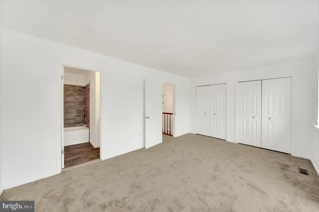 a view of an empty room and closet area