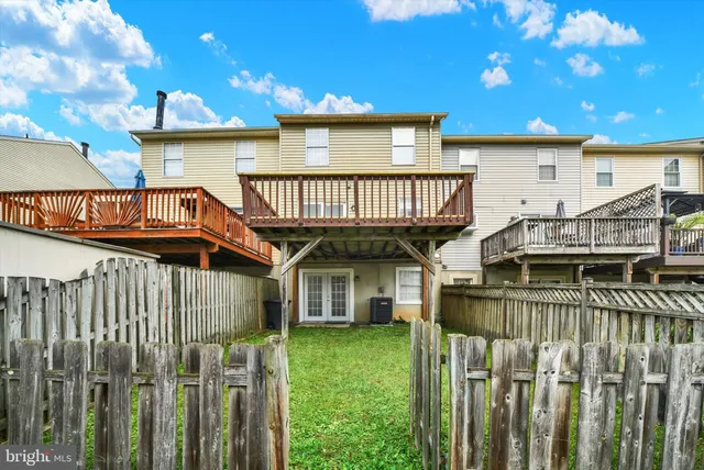 a view of a house with wooden deck