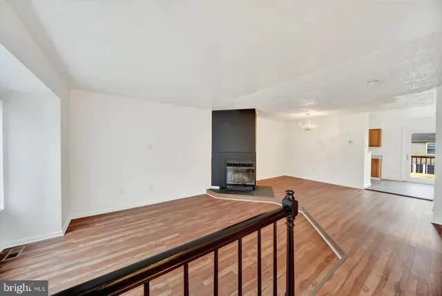 a view of a room with wooden floor and staircase