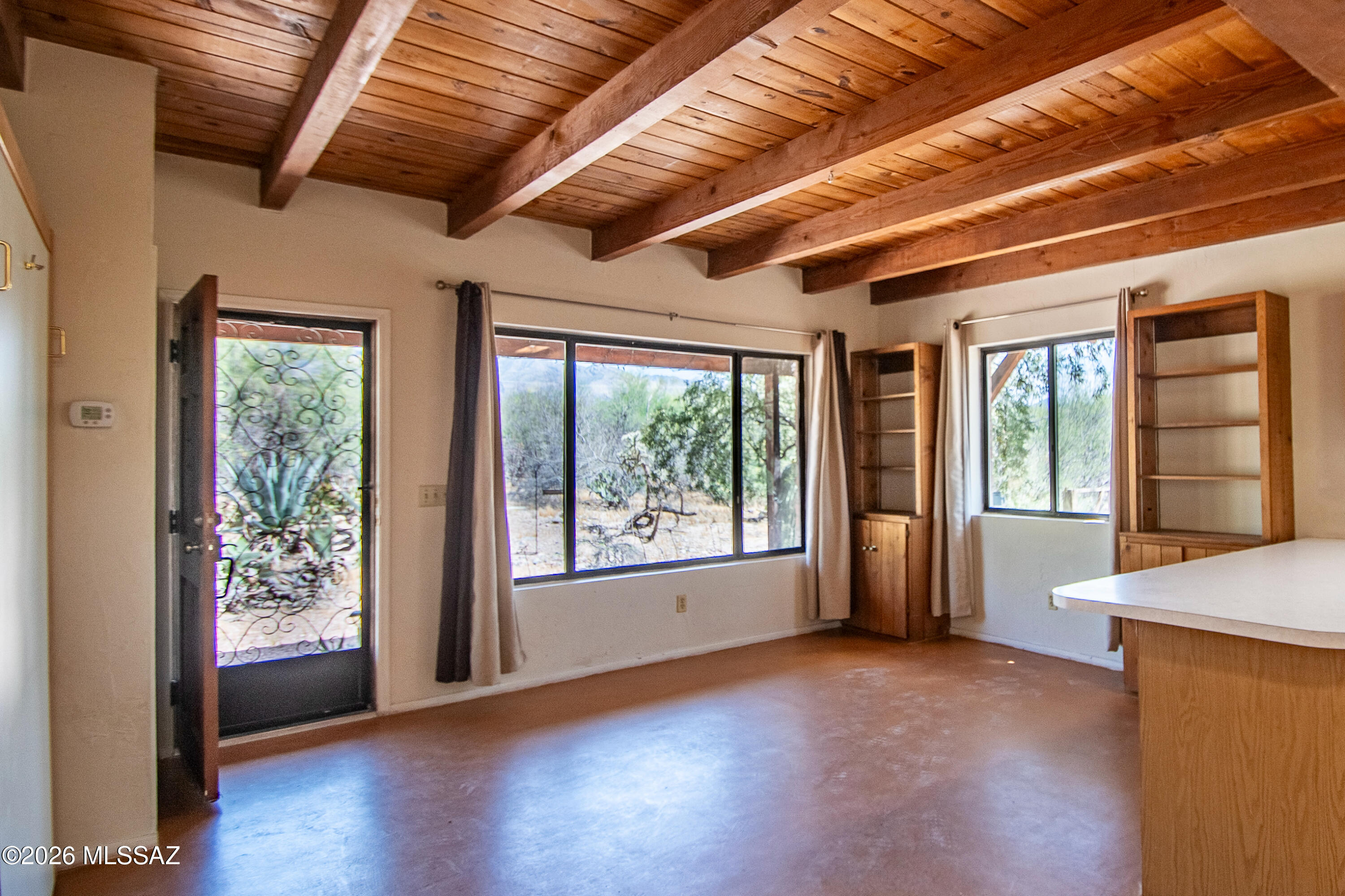 4130 East River Road Tucson, AZ 85718 - Photo 36 of 46 a view of an empty room with wooden floor and a window