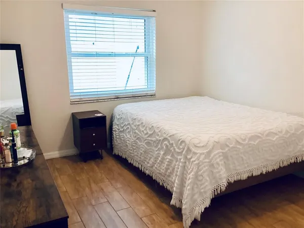 a bed sitting in a bedroom next to a window