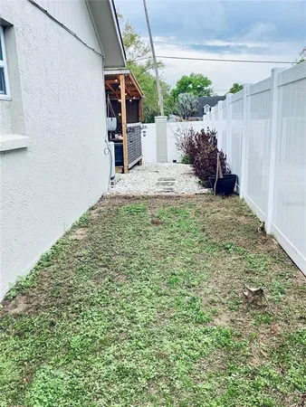 a backyard of a house with a tree