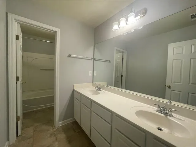 a bathroom with a toilet and a bath tub