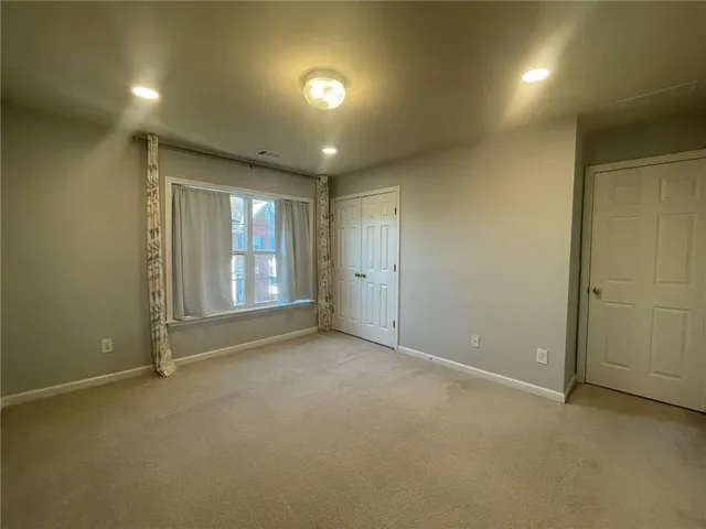 a large bathroom with a tub sink shower and mirror