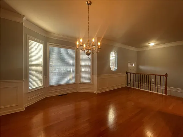 a view of a room with window and hardwood floor
