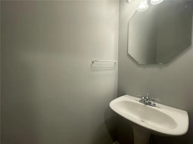 a bathroom with a sink a toilet and mirror