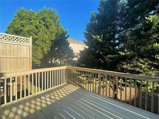 a view of balcony with wooden floor and fence