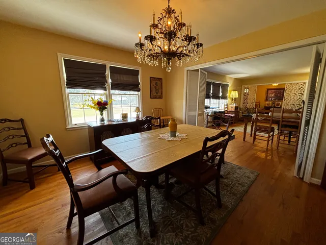 a view of a dining room with furniture and chandelier