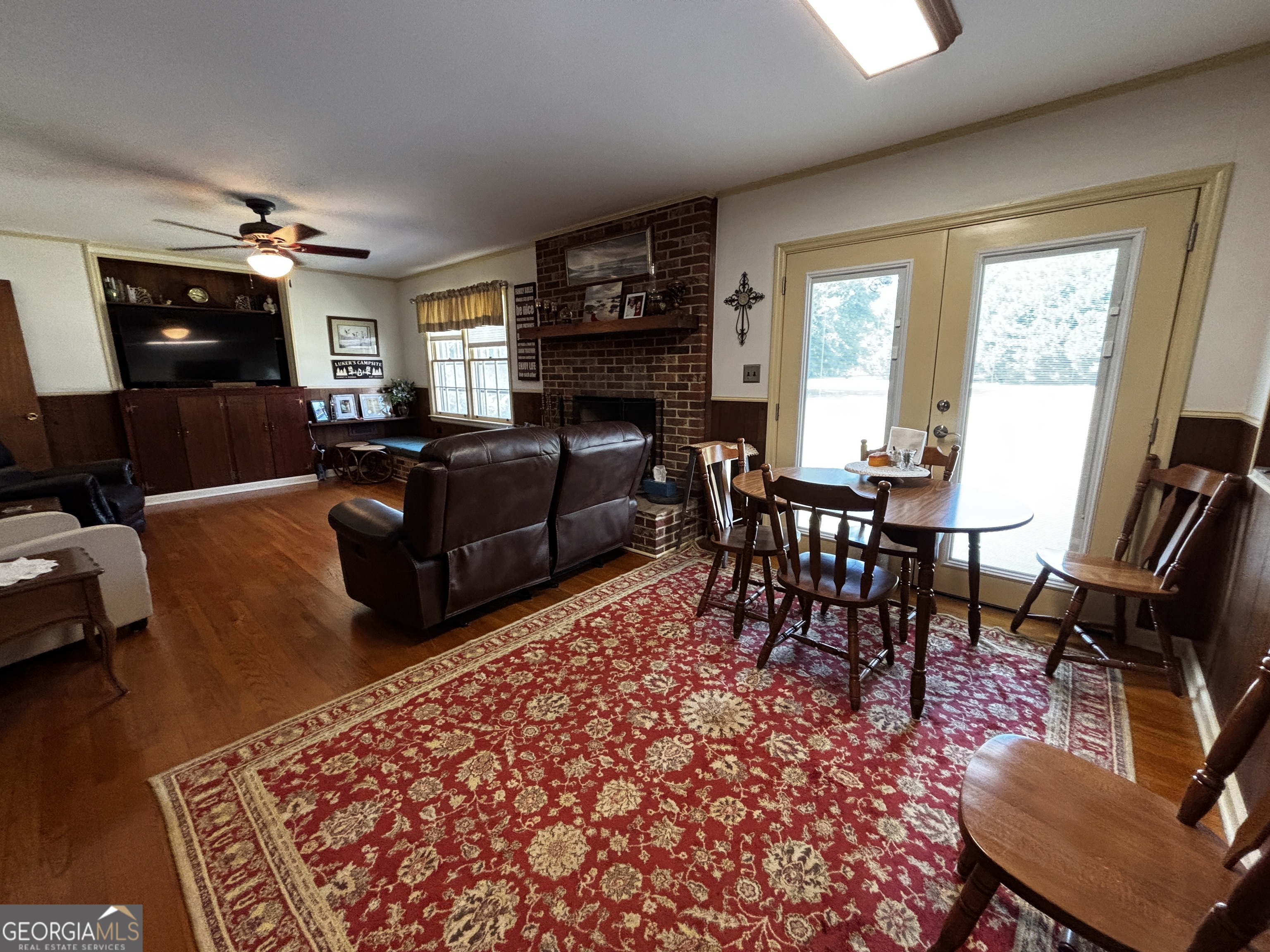 207 Old Thomson Road Wrens, GA 30833 - Photo 19 of 46 a living room with furniture a flat screen tv and a fireplace