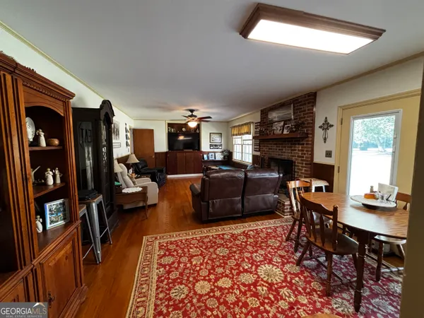 a living room with furniture fireplace and a window